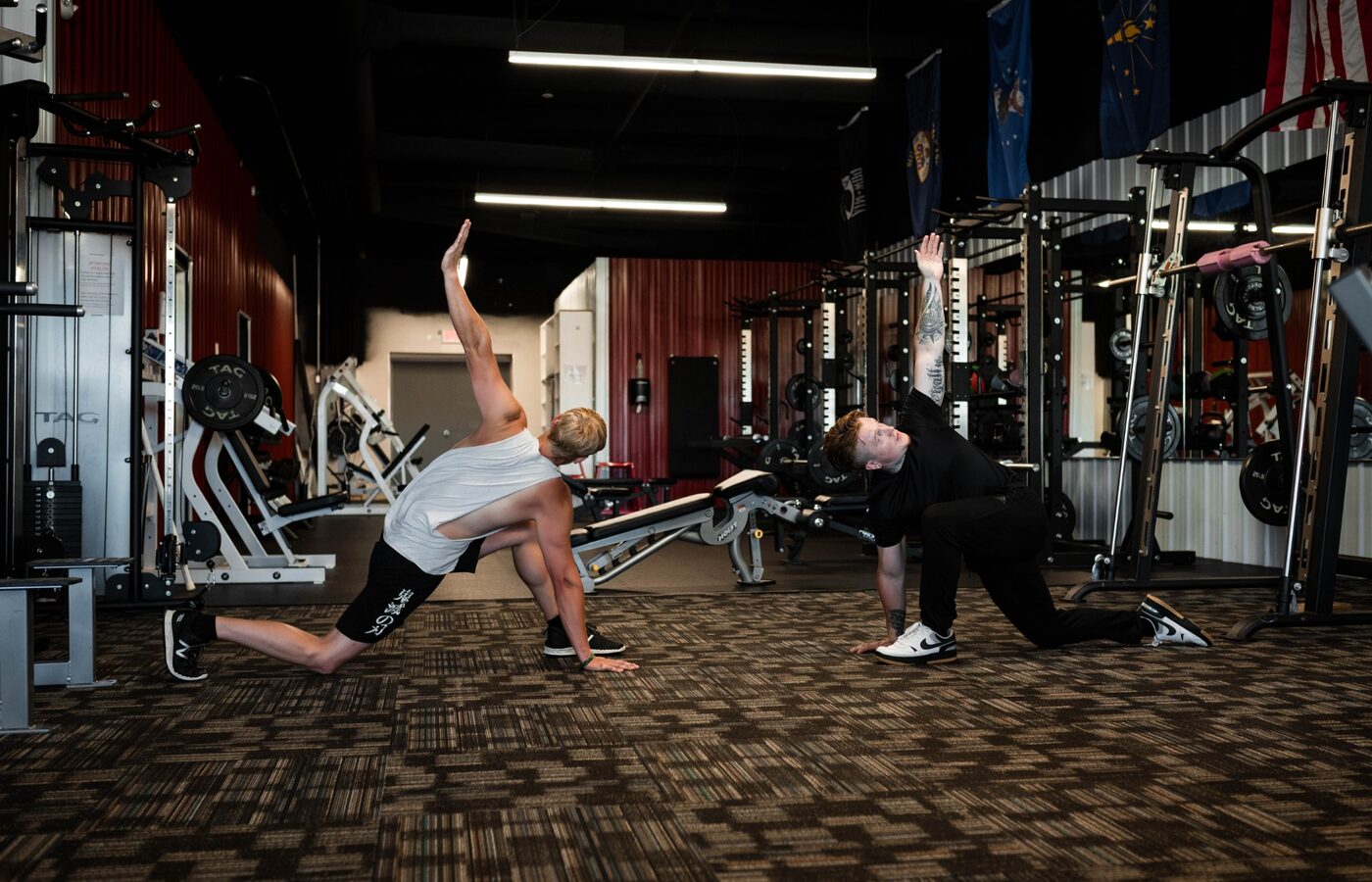 Jacob and a client performing mobility work in the gym